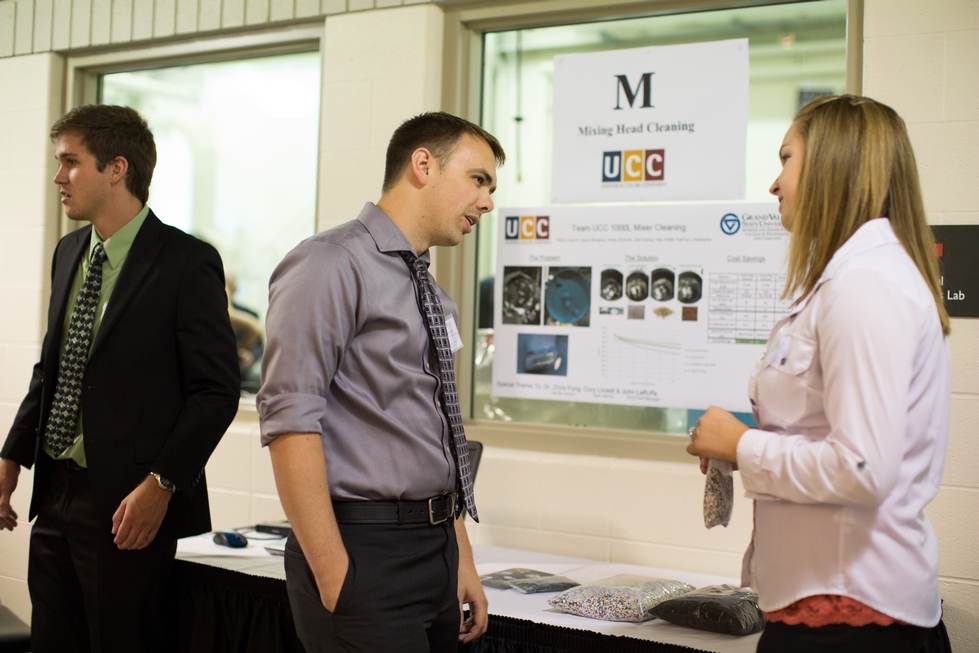 Two people discussing a poster presentation